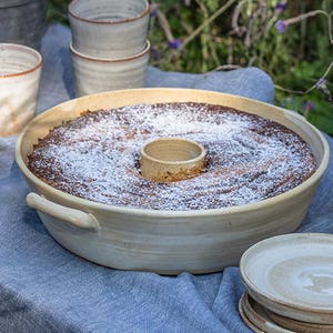 A silky White bundt cake baking dish on a festive table in the garden.