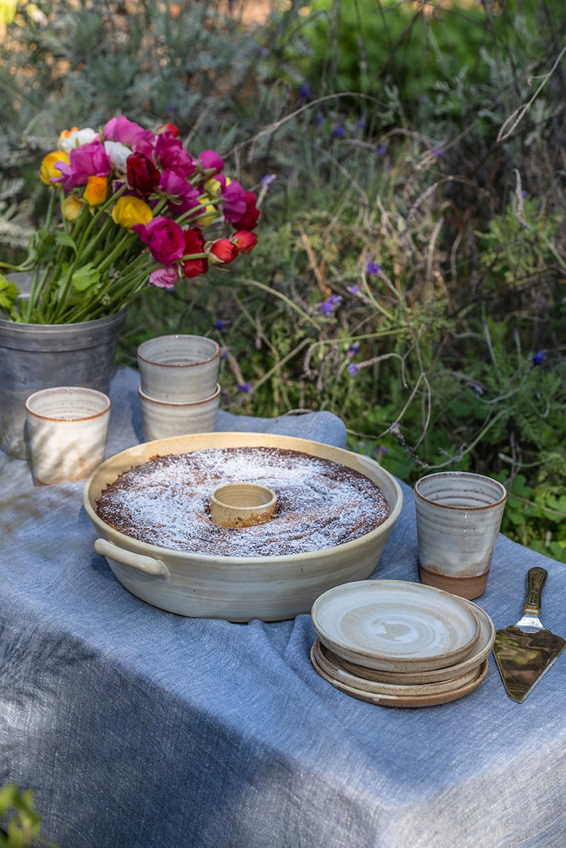 A silky White bundt cake baking dish on a festive table in the garden.