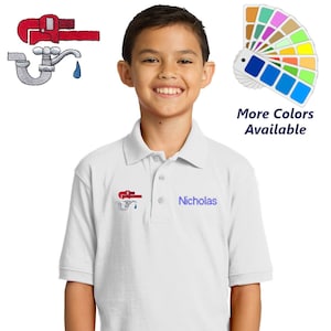 May include: White polo shirt with a red wrench and faucet embroidered on the left chest. The shirt has a blue button and the name "Nicholas" embroidered on the right chest. The image also shows a color palette with the text "More Colors Available".