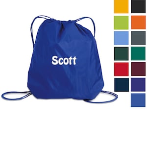 May include: A royal blue drawstring bag with white drawstring cords and the name "Scott" embroidered in white on the front.