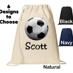 May include: A white drawstring bag with a black and white soccer ball design and the name "Scott" printed on it. The bag is available in natural, black, and navy colors.