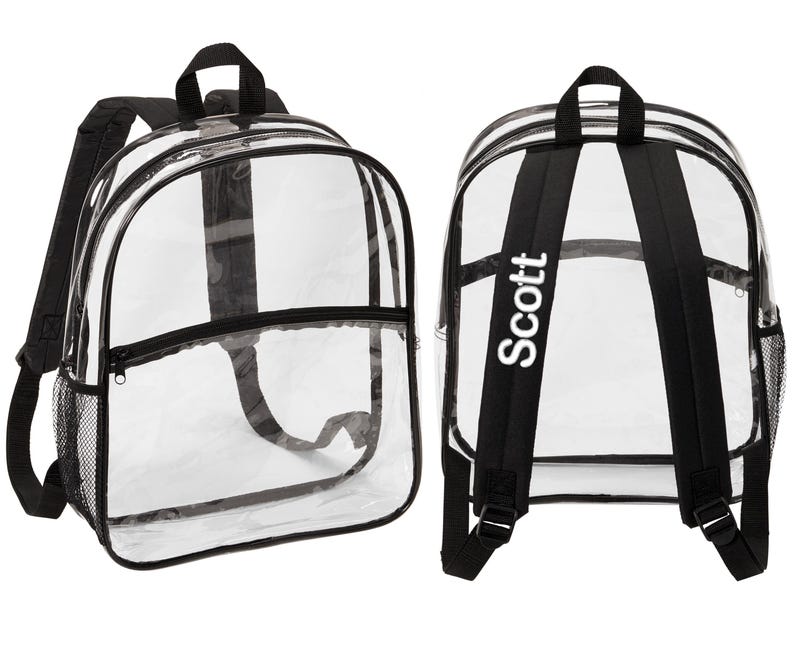 May include: Clear plastic backpack with black straps and a black zippered pocket. The backpack has a mesh pocket on the side and the name "Scott" is printed on the back strap in white.