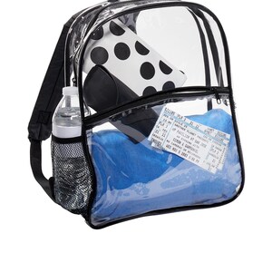 May include: A clear plastic backpack with black straps and a mesh side pocket. The backpack is filled with a blue towel, a water bottle, a black and white polka dot pouch, and a concert ticket for Simon & Garfunkel.