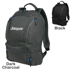 May include: A dark charcoal backpack with a zippered front pocket and a mesh back panel. The backpack has a blue zipper pull and the word "Jasper" embroidered on the front.