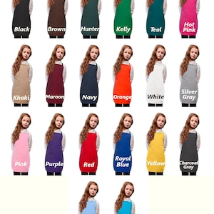 May include: A collection of aprons in various colors, including black, brown, hunter green, Kelly green, teal, hot pink, khaki, maroon, navy, orange, white, silver gray, pink, purple, red, royal blue, yellow, charcoal gray, light blue, and turquoise. Each apron is displayed on a young person.