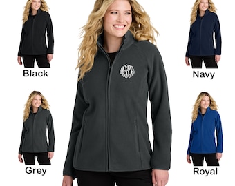 May include: A women's fleece jacket with a zipper closure and a monogram on the chest. The jacket is available in black, navy, grey, and royal blue.
