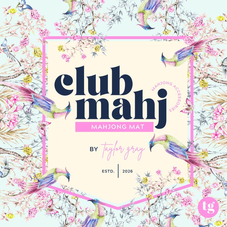 May include: A light blue background with a floral and bird pattern surrounds a cream-colored hexagon. The hexagon contains the words "club mahj" in navy blue, with "mahjong mat" below. The text "by taylor gray" is also present.