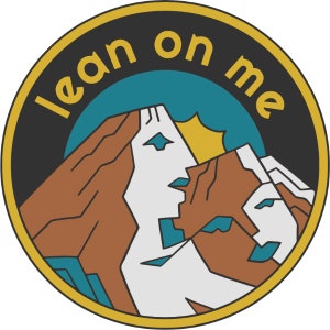 May include: A yellow, black, and brown circular sticker with the text "lean on me" in a white outline. The sticker features a stylized image of two mountains with a yellow sun.