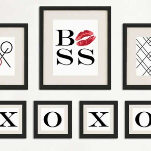 May include: A set of eight black framed prints with white backgrounds. The prints feature the words "XOXO" and "BOSS" with a red lip print. One print features a black and white geometric pattern.