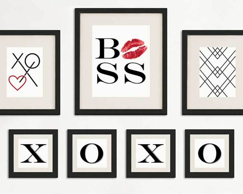 May include: A set of eight black framed prints with white backgrounds. The prints feature the words "XOXO" and "BOSS" with a red lip print. One print features a black and white geometric pattern.