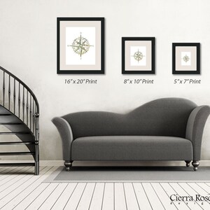 May include: Three framed prints of a compass design in different sizes. The largest print is 16 inches by 20 inches, the middle print is 8 inches by 10 inches, and the smallest print is 5 inches by 7 inches.
