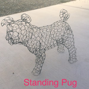 May include: A wire mesh sculpture of a standing pug dog. The sculpture is made of a wire mesh material and is shaped like a pug dog. The sculpture is standing on a light gray surface. The text "Standing Pug" is written below the sculpture.