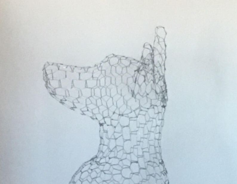 May include: A wire mesh sculpture of a dog's head, viewed from the side. The sculpture is made of a fine wire mesh, creating a delicate and intricate design.