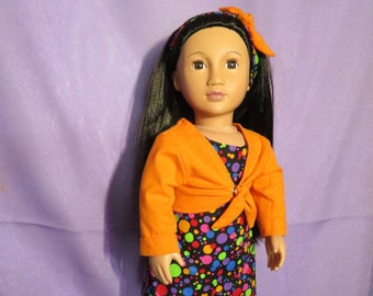 Sleeveless polka-dotted mini-dress fits American Girl & 18 in dolls. Features bright long-sleeve cardigan in orange, purple or lime green.