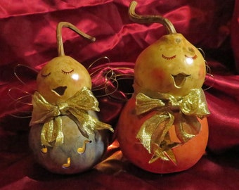 Finished Gourd angel ornament. Place tree light onto rear opening to light dried gourd angel with ribbon bow and wire wings.