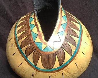 Western theme dried & painted gourd with gold, turquoise and brown details on natural gourd. Feather look band.