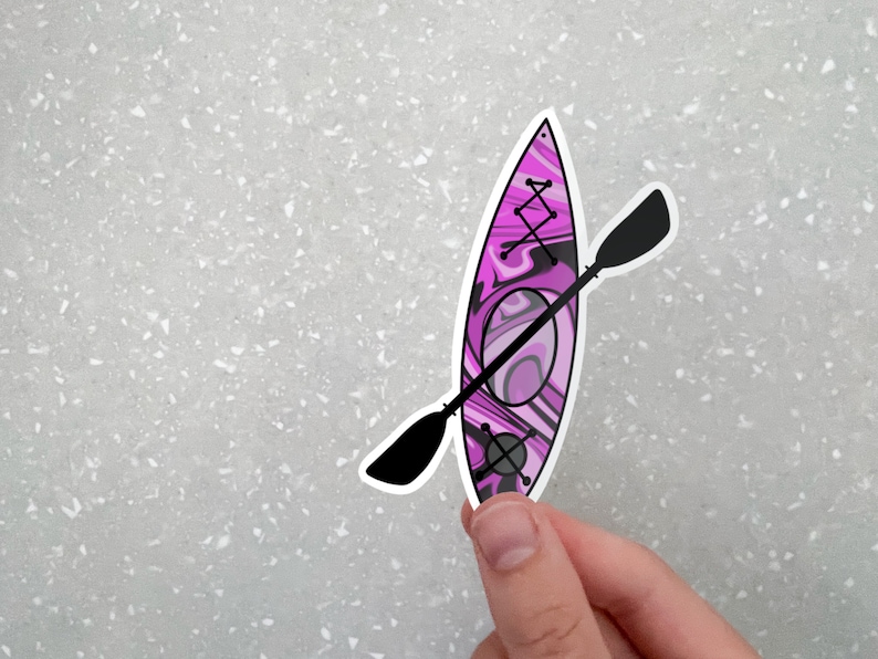 May include: A pink and black kayak sticker with a black paddle. The kayak has a swirl pattern.