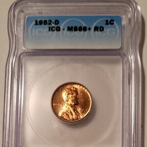 May include: A 1982-D Lincoln penny graded MS66+ RD by the Independent Coin Grading Service (ICGS) in a plastic slab with a 1C label.
