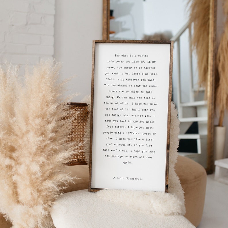 May include: A framed print with a white background and black text. The text is a quote by F. Scott Fitzgerald about the importance of making the best of life and having the courage to start over. The quote is printed in a typewriter font.