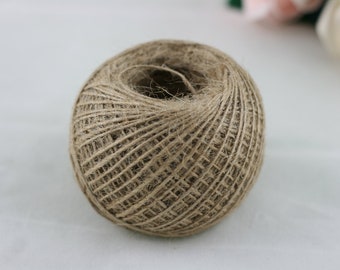 May include: A ball of natural brown twine, made from jute fibres, is ready for crafting projects.