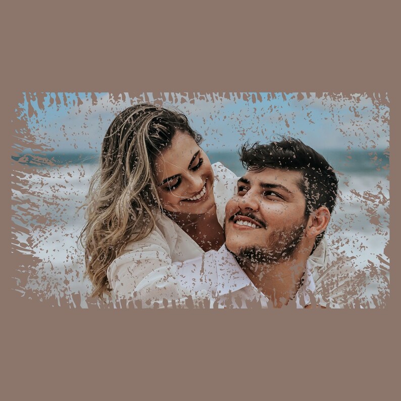 May include: A couple gaze at each other with smiles on their faces. The woman is wearing a white shirt and the man is wearing a white shirt. The background is a blurred image of a beach.