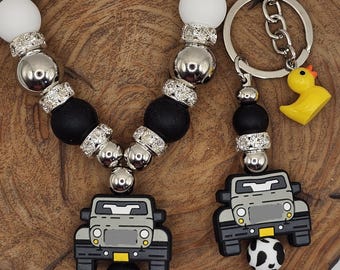 Llavero o pulsera de cuentas de silicona con dije de pato para camioneta todoterreno 4x4 en blanco y negro con detalles brillantes
