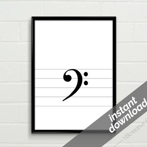 May include: Black and white printable art print of a bass clef on a musical staff. The print is framed in a black frame.