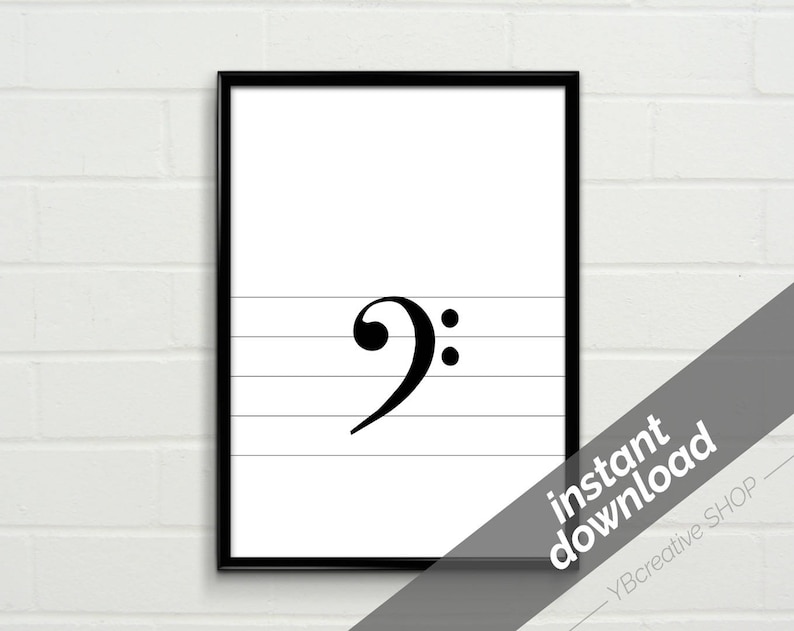 May include: Black and white printable art print of a bass clef on a musical staff. The print is framed in a black frame.