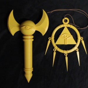 May include: A golden staff with a crescent moon shaped top and an eye symbol. A golden pendant with a triangle and eye symbol hangs from a brown cord.