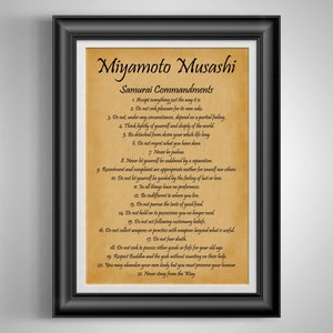 May include: Framed print featuring the text "Miyamoto Musashi Samurai Commandments" in a decorative font. The print has a parchment-like background and a black frame. The text lists 21 principles.