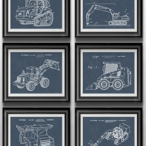 May include: A set of six framed prints featuring vintage blueprints of different types of construction equipment. The prints are on a blue background with white lines. The equipment includes a tractor, an excavator, a bulldozer, a skid steer loader, a dump truck, and a backhoe.