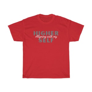 May include: Red t-shirt with the text "HIGHER Aligning with my SELF" in gray lettering.