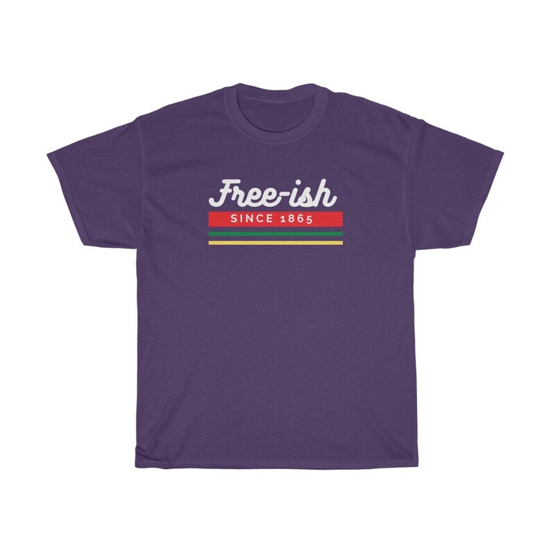 May include: A purple t-shirt with the text "Free-ish" in white script above a horizontal stripe design. The stripe design includes red, green, and yellow bands, with the text "SINCE 1865" below the script.