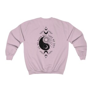 May include: A pink sweatshirt with a black yin yang symbol and the text "Do no harm but take no shit" printed on the back.