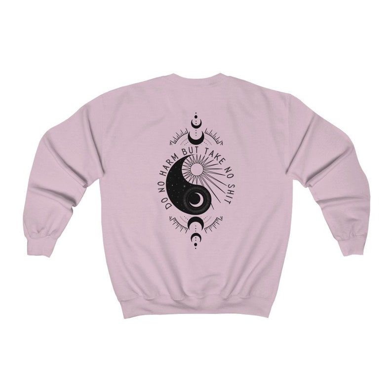 May include: A pink sweatshirt with a black yin yang symbol and the text "Do no harm but take no shit" printed on the back.