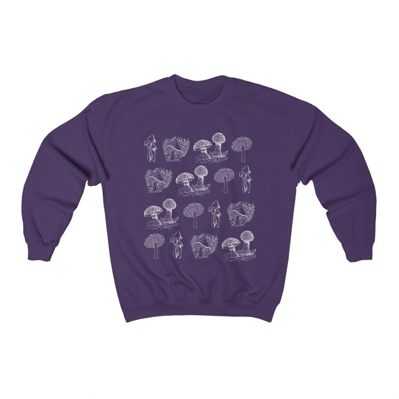 May include: Purple sweatshirt with a white outline of various mushrooms printed on the front.
