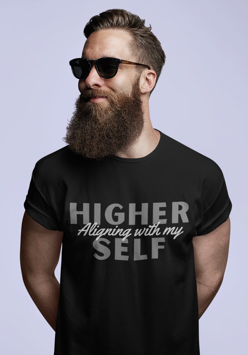 May include: Black t-shirt with the text "HIGHER Aligning with my SELF" in gray lettering.