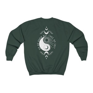 May include: A dark green sweatshirt with a white yin yang symbol and the text "Do no harm but take no shit" printed on the back.