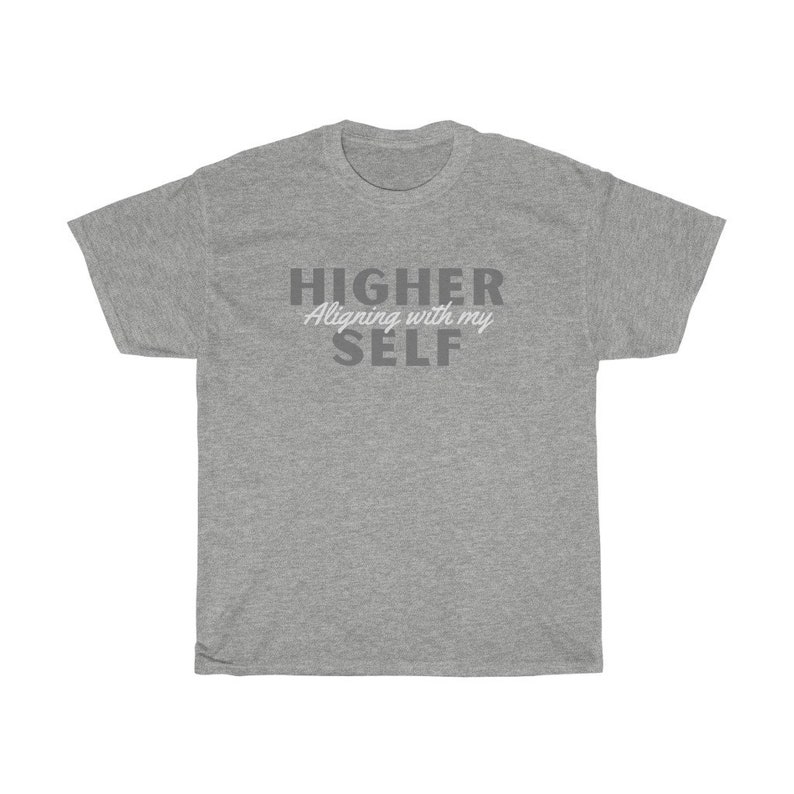 May include: Gray t-shirt with the text "HIGHER Aligning with my SELF" in gray and white lettering.