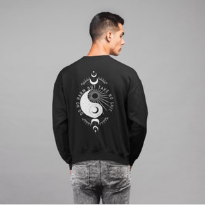 May include: Black sweatshirt with a white yin yang symbol and the text "Do no harm but take no shit" on the back.