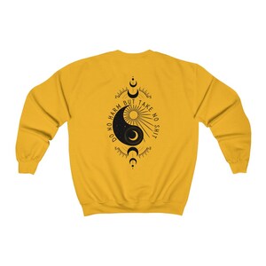 May include: Yellow sweatshirt with a black yin yang symbol and the text "Do no harm but take no shit" printed on the back.