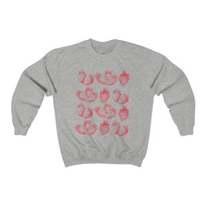 May include: A gray sweatshirt with a red strawberry print. The strawberries are arranged in rows and are outlined in black.