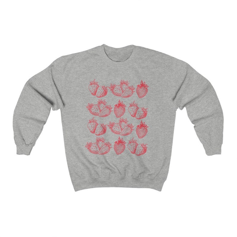 May include: A gray sweatshirt with a red strawberry print. The strawberries are arranged in rows and are outlined in black.