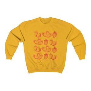 May include: A yellow sweatshirt with a red strawberry print. The strawberries are arranged in rows and are a vintage style illustration.