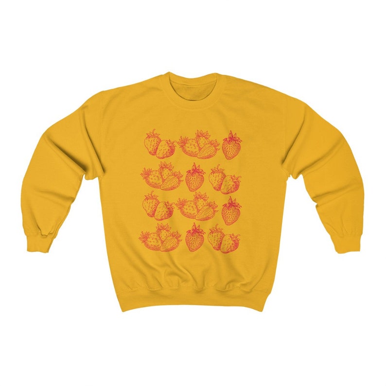 May include: A yellow sweatshirt with a red strawberry print. The strawberries are arranged in rows and are a vintage style illustration.