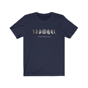 May include: Navy blue t-shirt with a graphic of the moon phases and the text "THE MOON MADE ME DO IT".