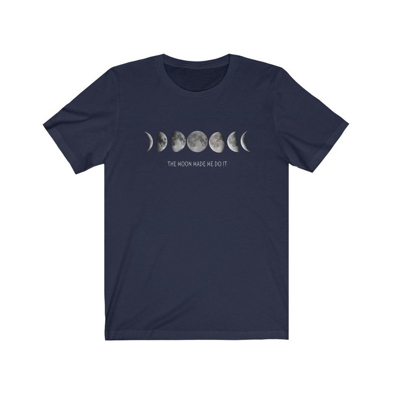May include: Navy blue t-shirt with a graphic of the moon phases and the text "THE MOON MADE ME DO IT".