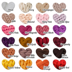 May include: A colour chart displaying 20 heart-shaped swatches of chunky knit yarn. Colours include white, ivory, champagne, linen, latte, almond, baby pink, white lilac, dark pink, hot magenta, pink blush, lilac, dark plum, meri gold, cherry, burgundy, dark beige, milk chocolate, chocolate, dark brown, lemon yellow, yellow, carrot orange, and bright red.