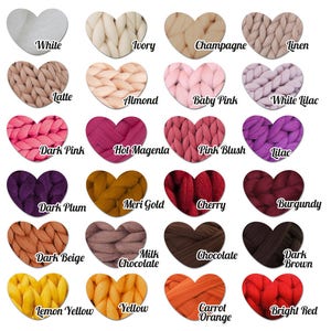 May include: A color chart featuring 20 heart-shaped swatches of chunky knit yarn. Colors include white, ivory, champagne, linen, latte, almond, baby pink, white lilac, dark pink, hot magenta, pink blush, lilac, dark plum, meri gold, cherry, burgundy, dark beige, milk chocolate, chocolate, dark brown, lemon yellow, yellow, carrot orange, and bright red.
