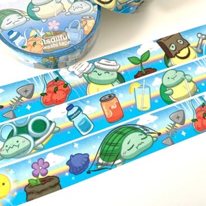 May include: Two rolls of blue and orange washi tape with a cartoon turtle design. The tape features the text "Reduce Reuse Recycle" and "itsdiful washi tape".
